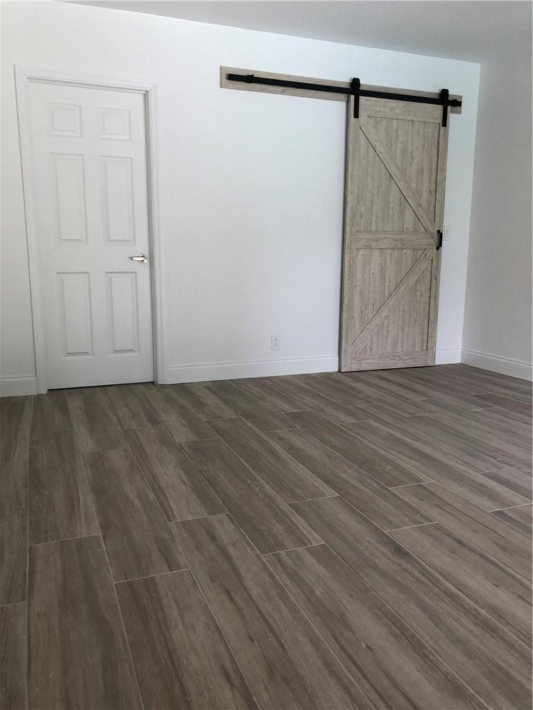 1230 Mulberry Way Boca Raton, FL 33486 - Photo 22 of 31 a view of an empty room with wooden floor