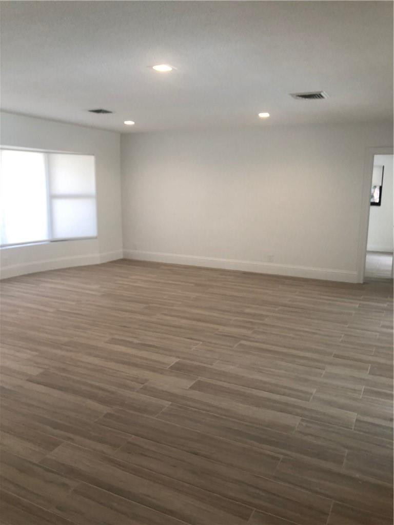1230 Mulberry Way Boca Raton, FL 33486 - Photo 26 of 31 wooden floor in an empty room with a window