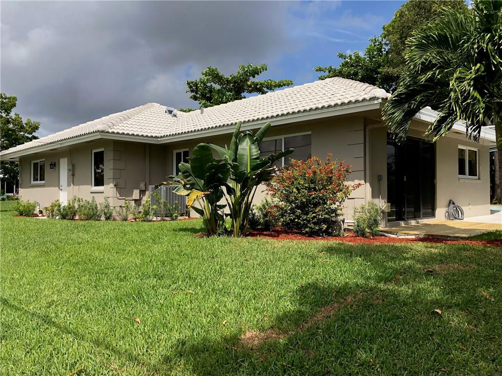 1230 Mulberry Way Boca Raton, FL 33486 - Photo 3 of 31 a front view of a house with garden