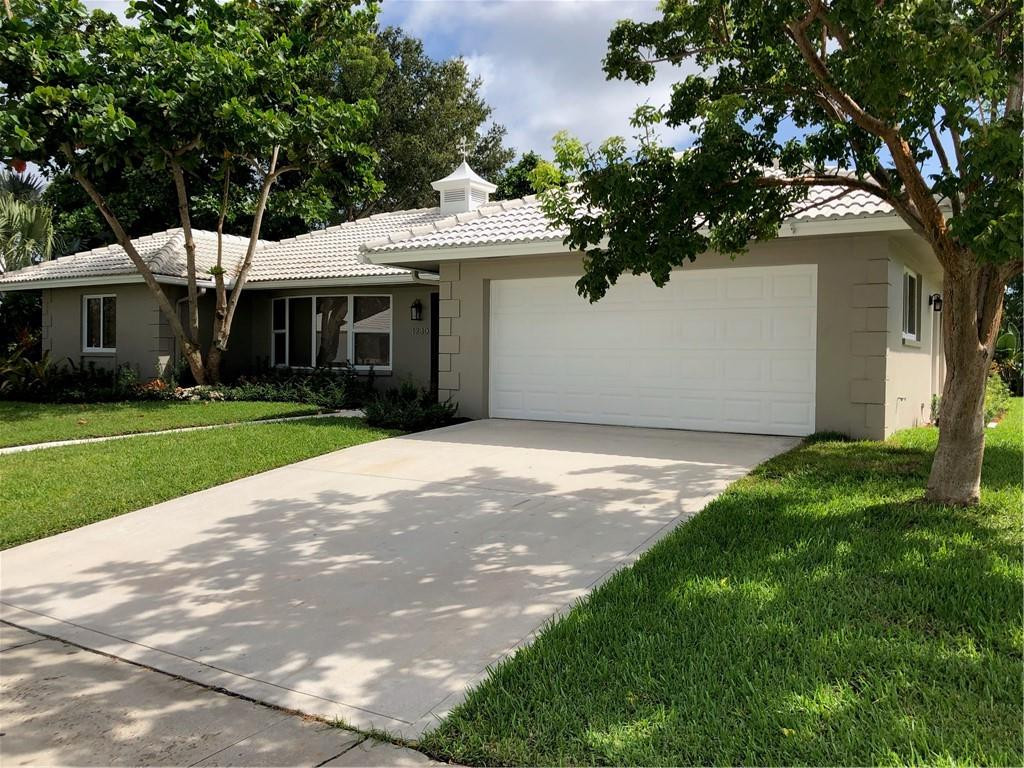 1230 Mulberry Way Boca Raton, FL 33486 - Photo 4 of 31 a view of a white house next to a yard and a large tree