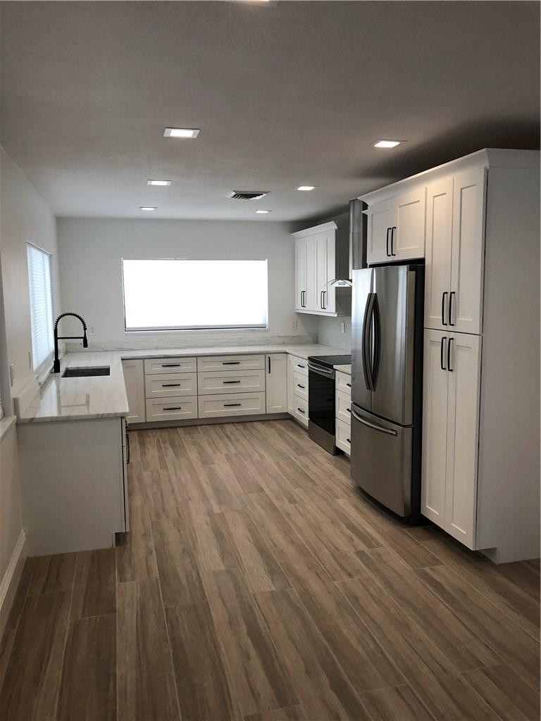 1230 Mulberry Way Boca Raton, FL 33486 - Photo 5 of 31 a large kitchen with a large window and stainless steel appliances