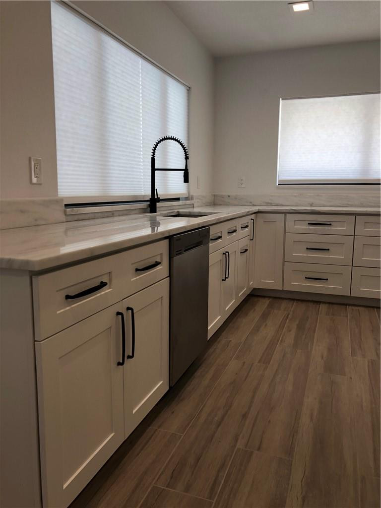 1230 Mulberry Way Boca Raton, FL 33486 - Photo 7 of 31 a kitchen with appliances a sink and cabinets