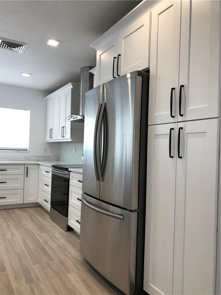 1230 Mulberry Way Boca Raton, FL 33486 - Photo 8 of 31 a kitchen with stainless steel appliances a refrigerator sink and cabinets