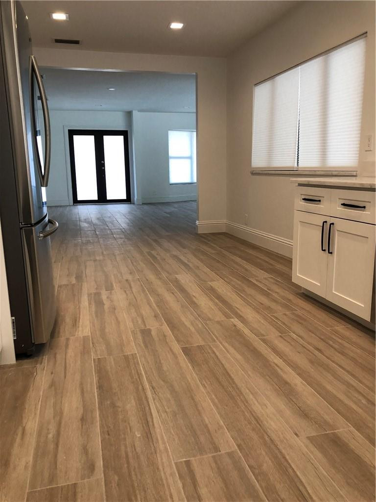 1230 Mulberry Way Boca Raton, FL 33486 - Photo 9 of 31 a view of a room with wooden floors and fireplace