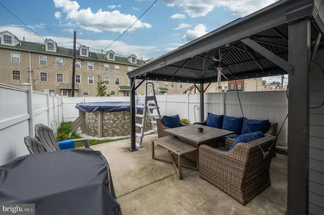 a roof deck with table and chairs