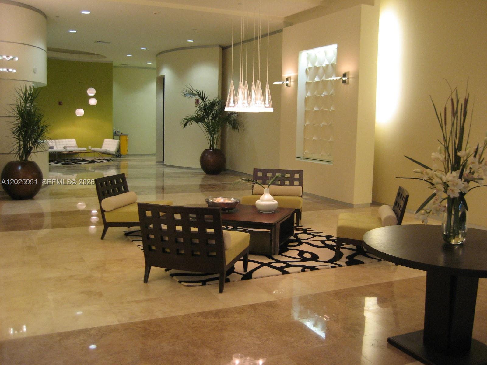 9066 Southwest 73rd Court, Unit 1802 Miami, FL 33156 - Photo 7 of 12 a room with gym equipment and a table