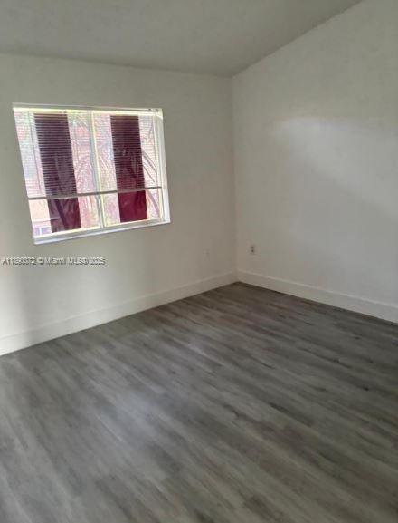 13447 Southwest 154th Street, Unit 2208 Miami, FL 33177 - Photo 9 of 11 a view of an empty room with wooden floor and a window