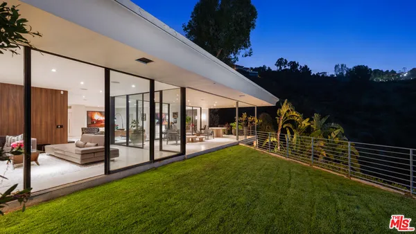 a swimming pool with outdoor seating and yard