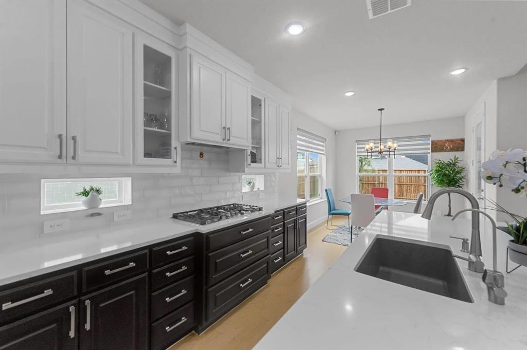 10969 Coastal Violet Road Frisco, TX 75035 - Photo 17 of 30 Kitchen featuring dark cabinetry, white cabinetry, a chandelier, decorative light fixtures, and recessed lighting
