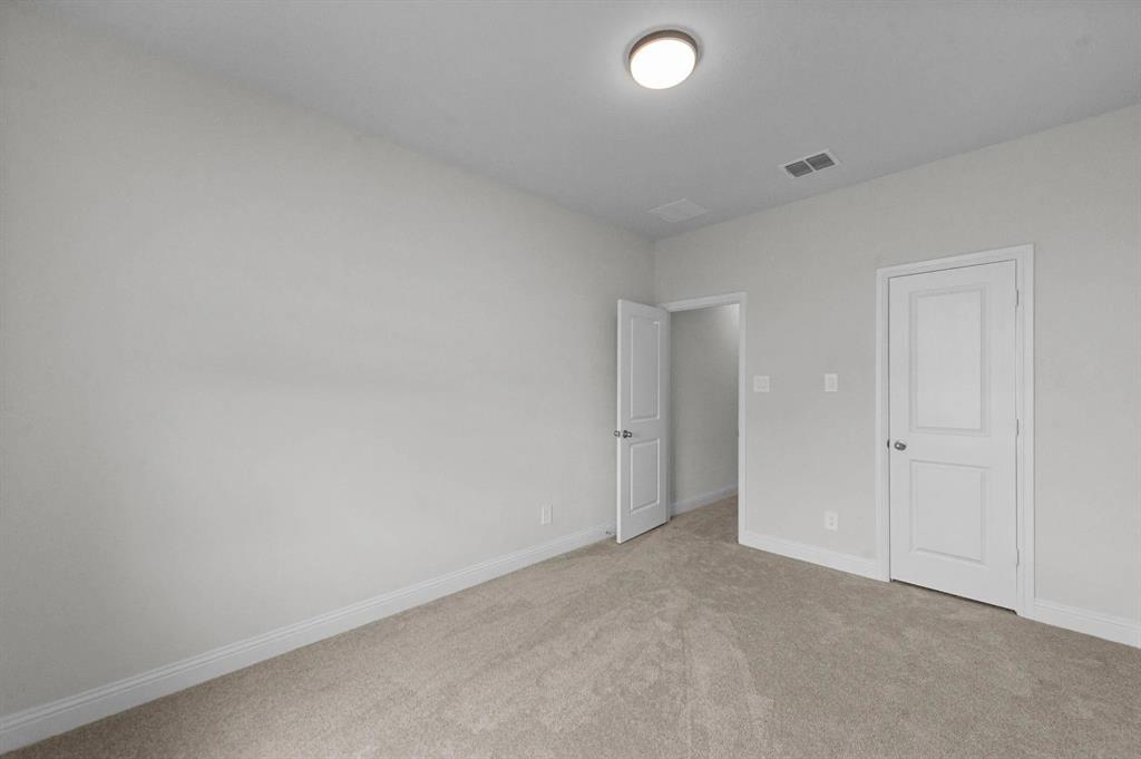 10969 Coastal Violet Road Frisco, TX 75035 - Photo 22 of 30 Unfurnished bedroom with light colored carpet and baseboards