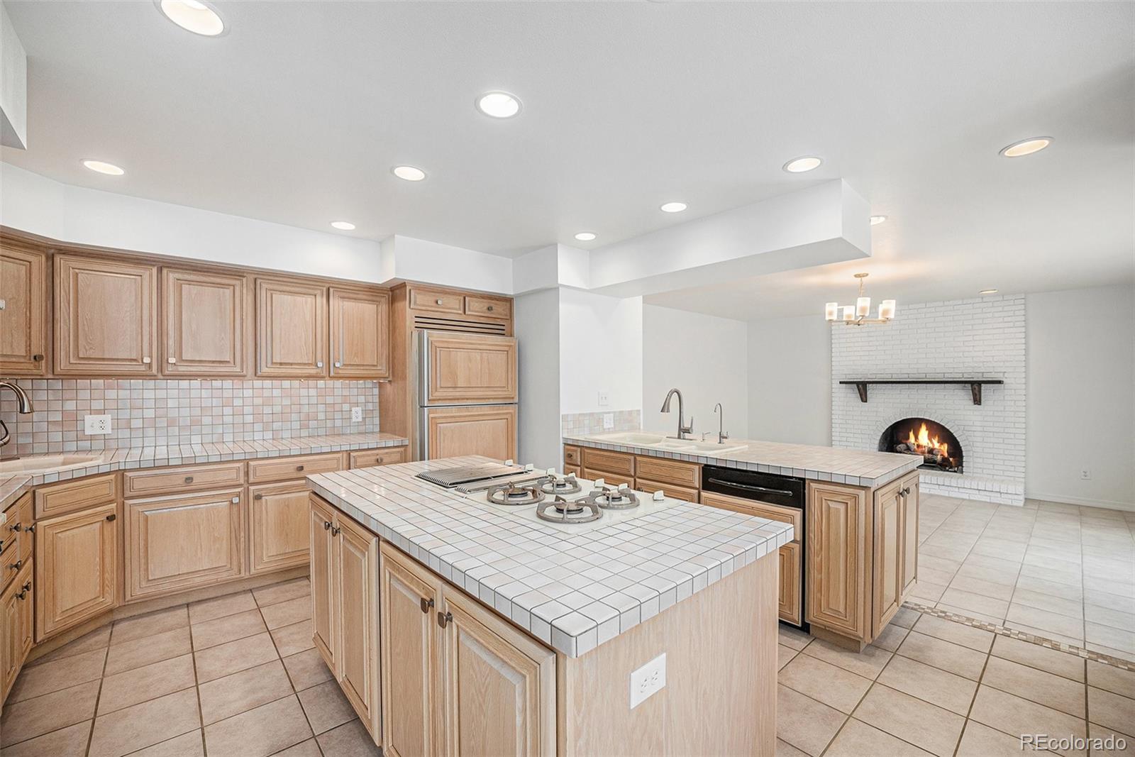 11802 West 77th Drive Arvada, CO 80005 - Photo 11 of 45 a kitchen with a sink stove and cabinets