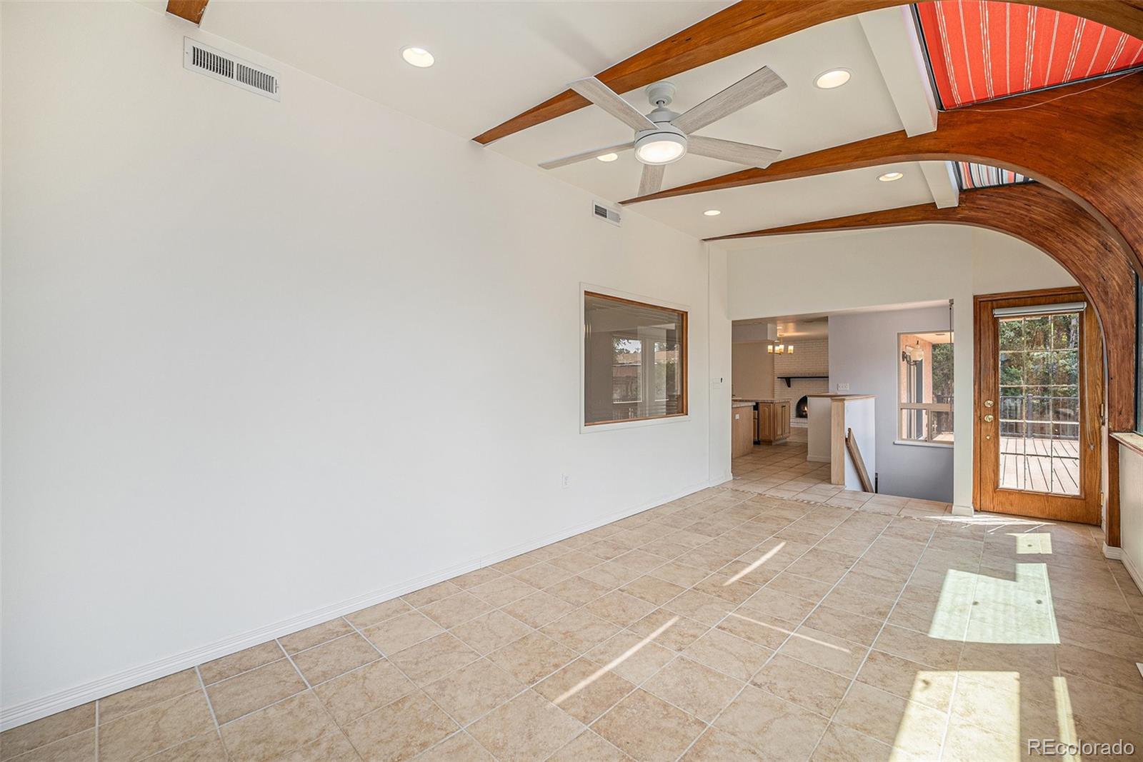 11802 West 77th Drive Arvada, CO 80005 - Photo 17 of 45 a view of a livingroom with wooden floor and a hallway