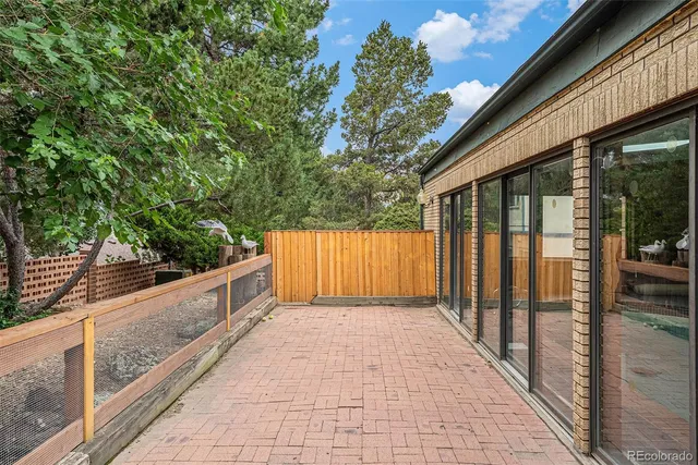 a balcony with wooden floor and fence