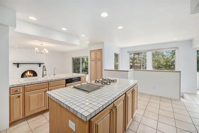 a kitchen that has a sink a stove and a table in it