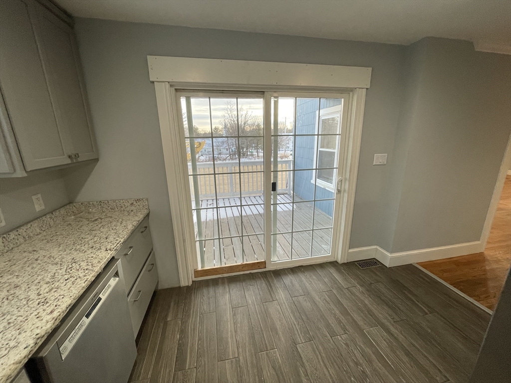 6 Brattle Street Worcester, MA 01606 - Photo 11 of 20 an empty room with wooden floor and entrance