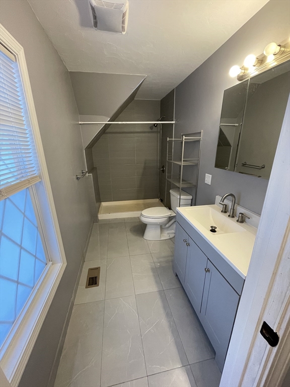 6 Brattle Street Worcester, MA 01606 - Photo 12 of 20 a bathroom with a sink a toilet and shower