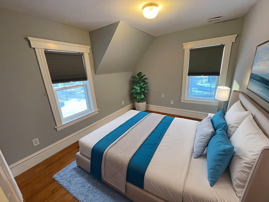 6 Brattle Street Worcester, MA 01606 - Photo 13 of 20 a bedroom with a bed and a window