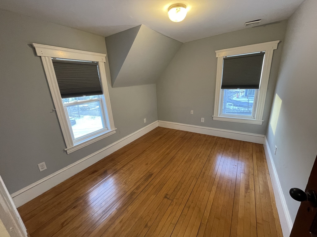 6 Brattle Street Worcester, MA 01606 - Photo 15 of 20 wooden floor in an empty room with a window