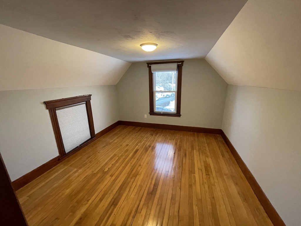 6 Brattle Street Worcester, MA 01606 - Photo 17 of 20 wooden floor in an empty room with a window