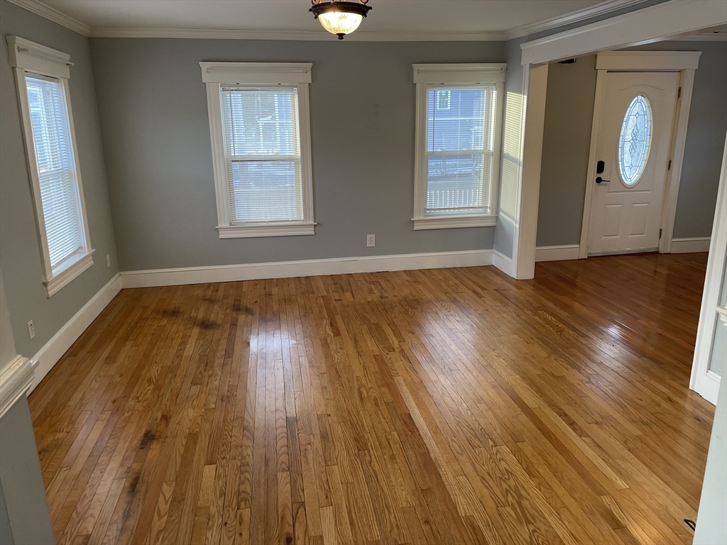 6 Brattle Street Worcester, MA 01606 - Photo 4 of 20 a view of an empty room with wooden floor and a window