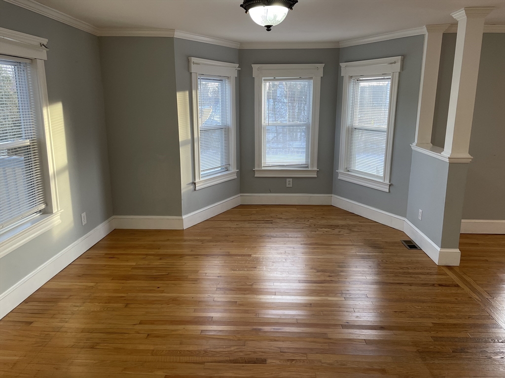 6 Brattle Street Worcester, MA 01606 - Photo 6 of 20 an empty room with wooden floor and windows