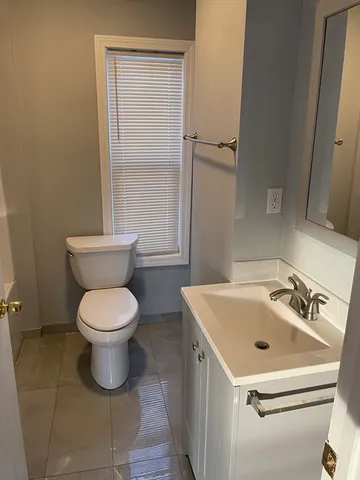 a white toilet sitting next to a bathroom sink