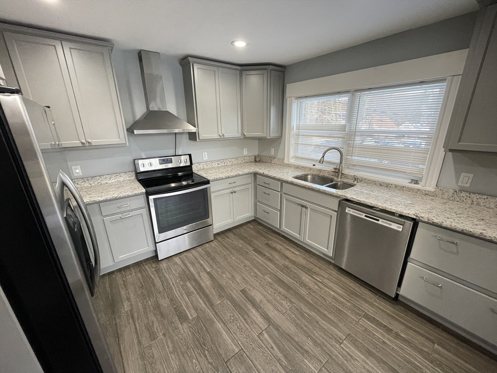 6 Brattle Street Worcester, MA 01606 - Photo 10 of 20 a kitchen with granite countertop a sink a stove and refrigerator