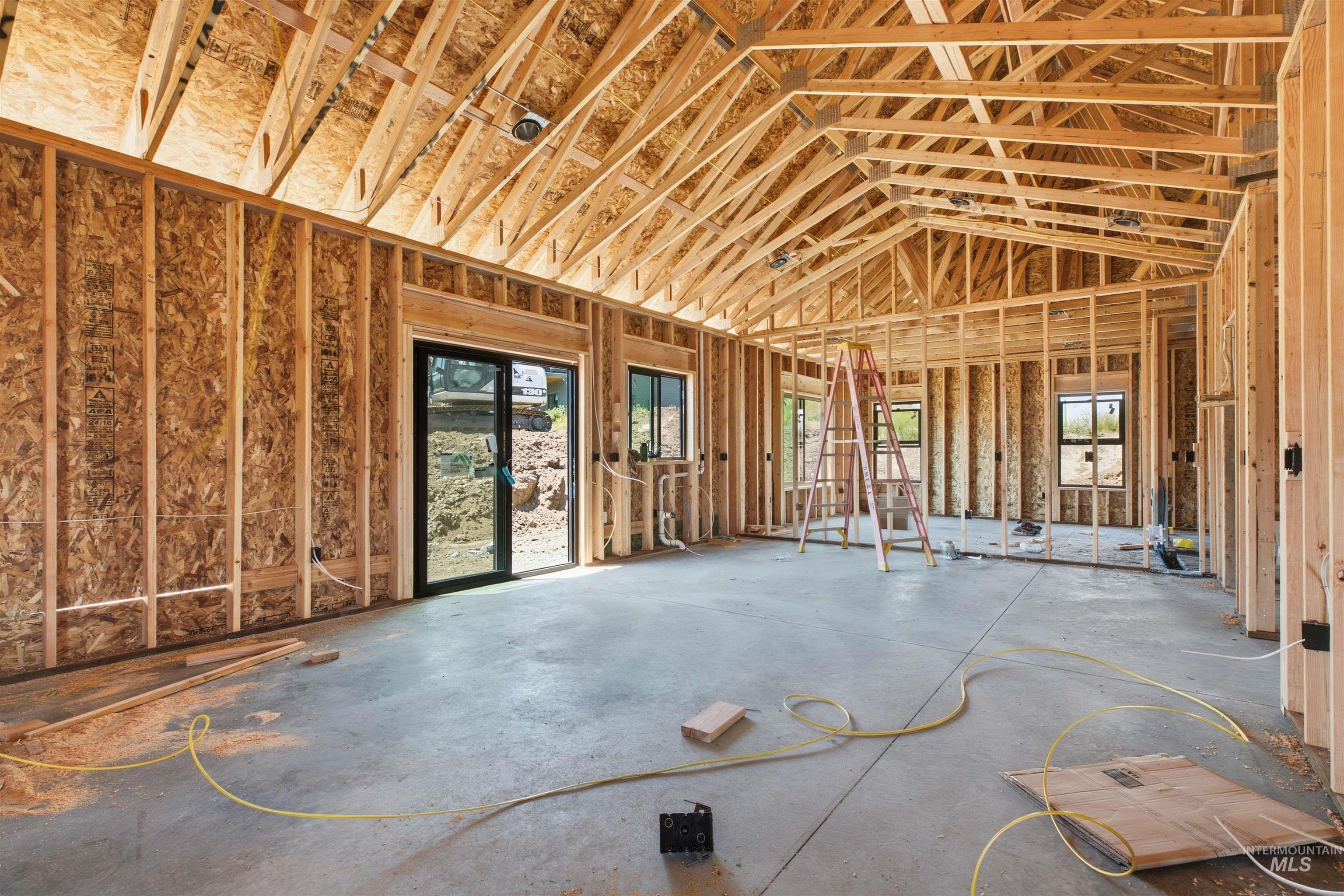 2824 Cyprus Court Moscow, ID 83843 - Photo 5 of 20 New construction framing with exposed wooden trusses and a concrete slab foundation