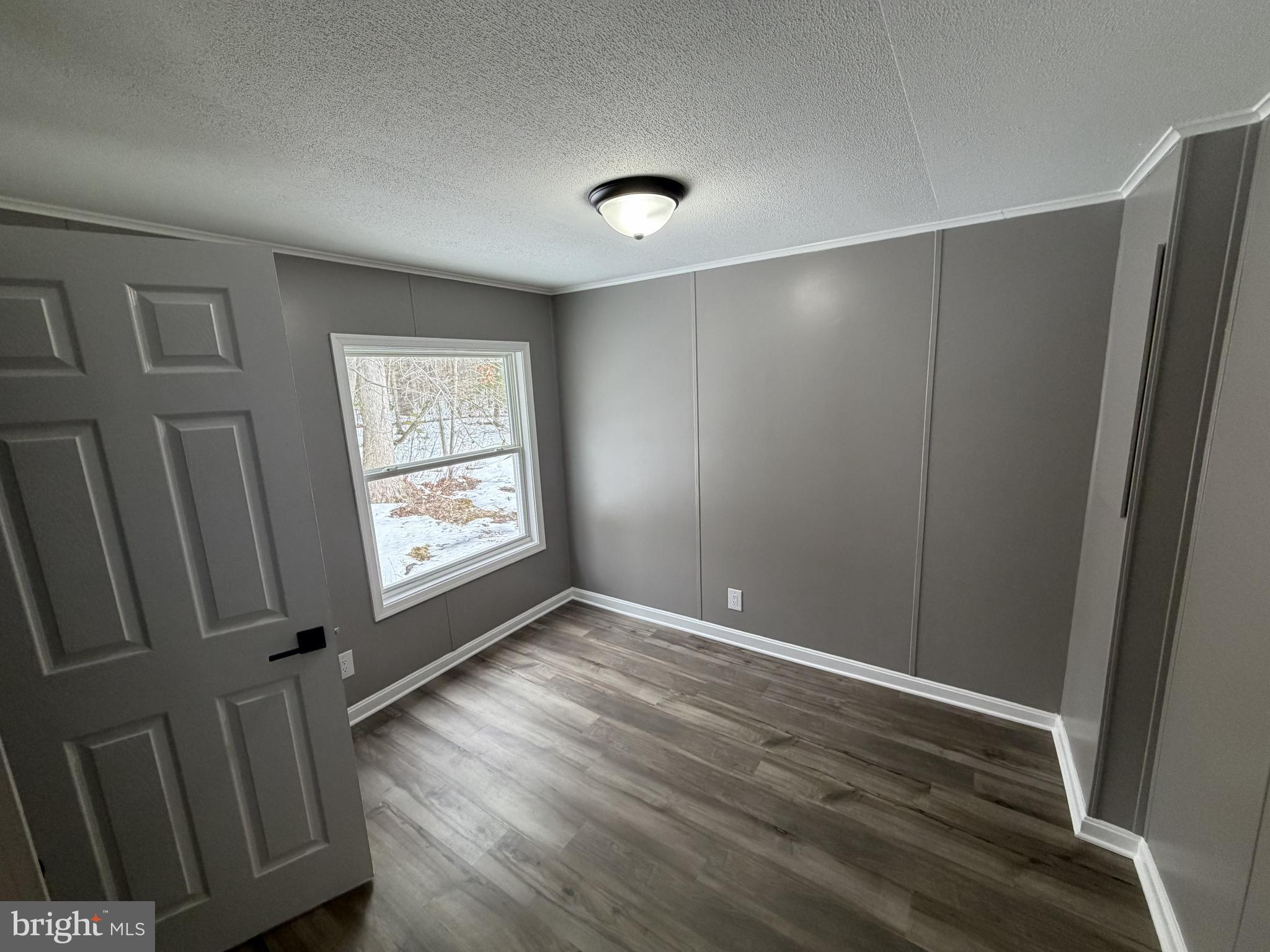 135 Cowhide Circle Middle River, MD 21220 - Photo 11 of 11 a view of an empty room with wooden floor and a window