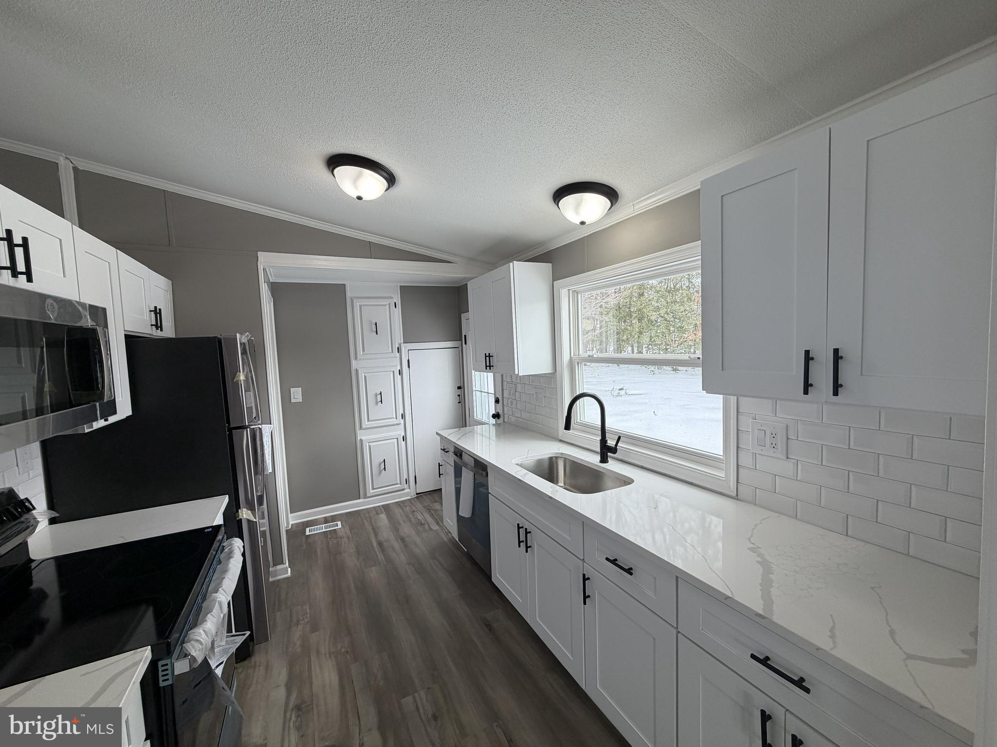 135 Cowhide Circle Middle River, MD 21220 - Photo 6 of 11 a kitchen with stainless steel appliances granite countertop a sink refrigerator and cabinets