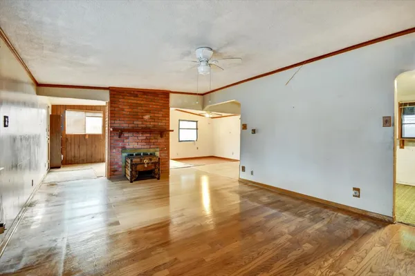 a view of livingroom with hardwood floor and a ceiling fan