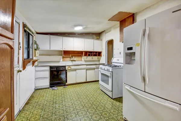 a kitchen with a refrigerator stove and sink