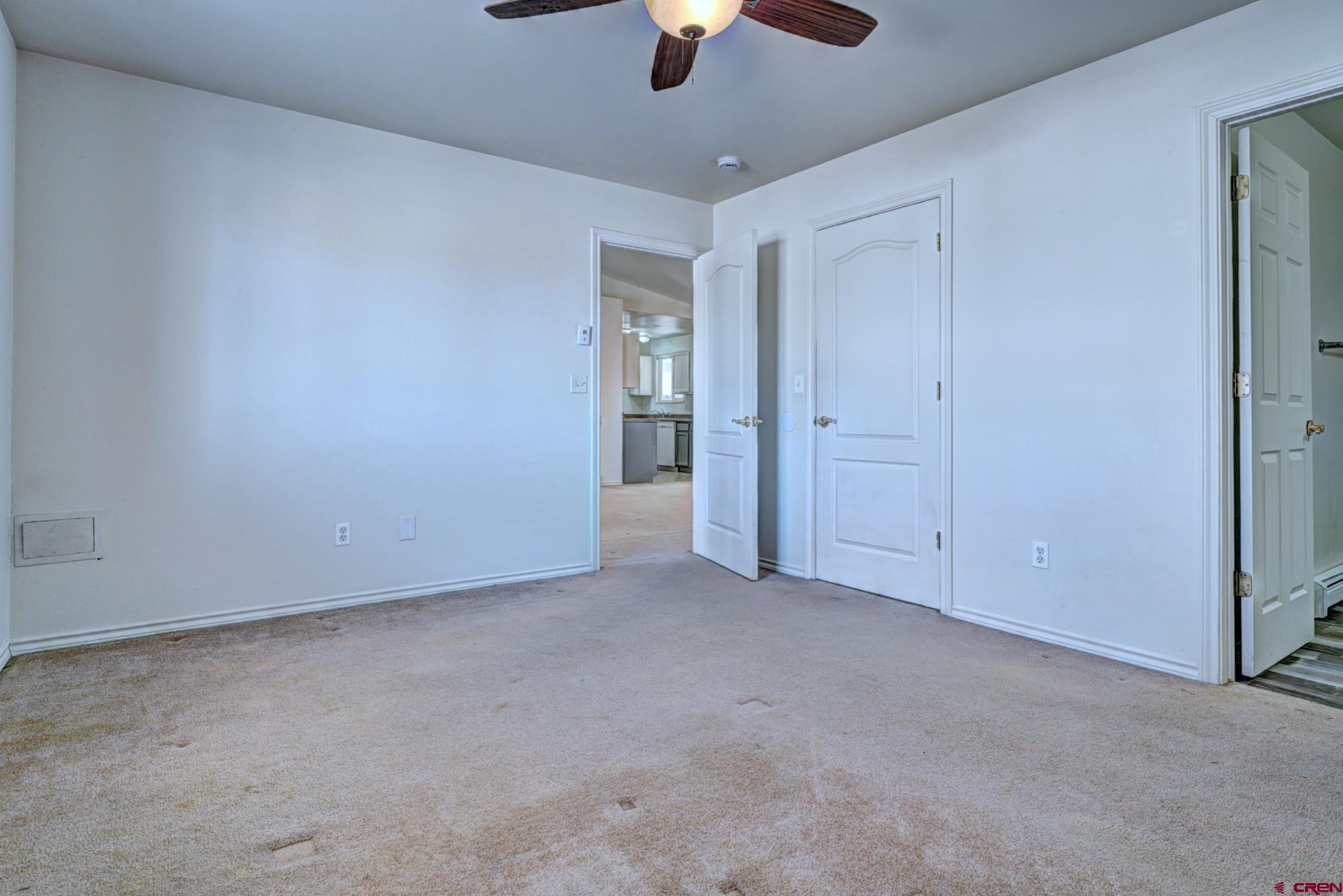 3119 D 3/4 Road Grand Junction, CO 81504 - Photo 15 of 31 an empty room with chandelier fan and windows