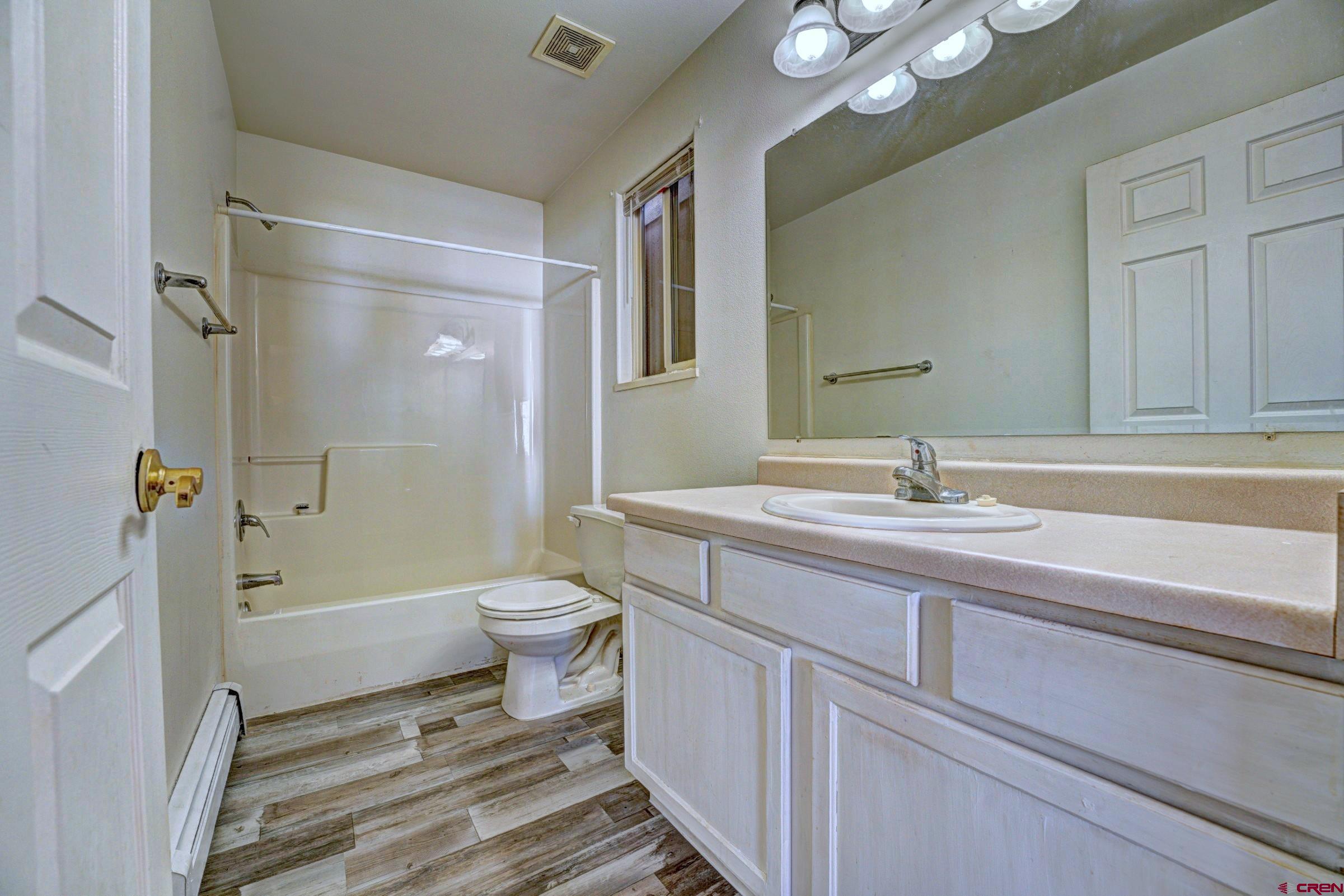 3119 D 3/4 Road Grand Junction, CO 81504 - Photo 16 of 31 a bathroom with a sink a toilet a mirror and shower