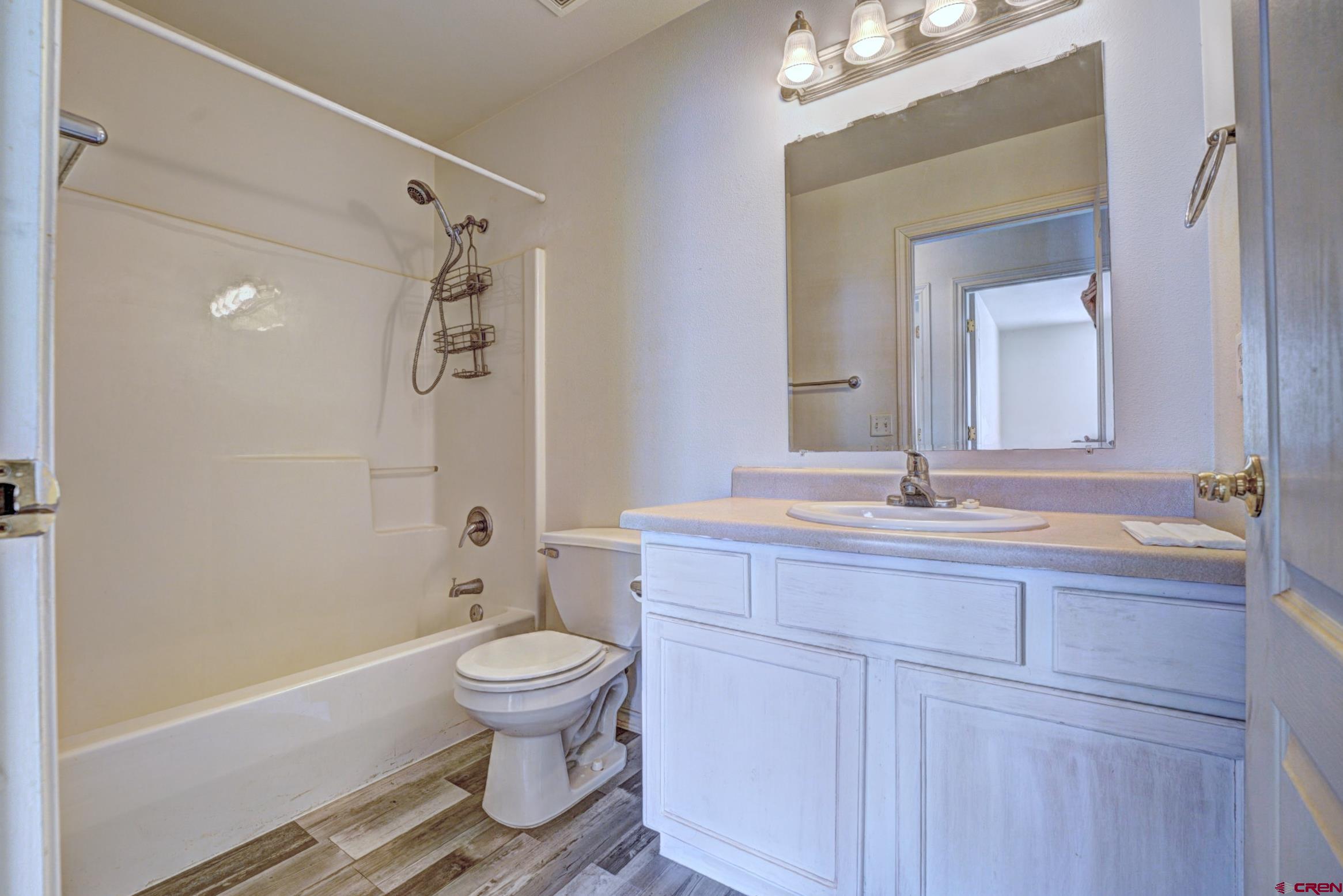 3119 D 3/4 Road Grand Junction, CO 81504 - Photo 19 of 31 a bathroom with a granite countertop toilet a sink and a mirror