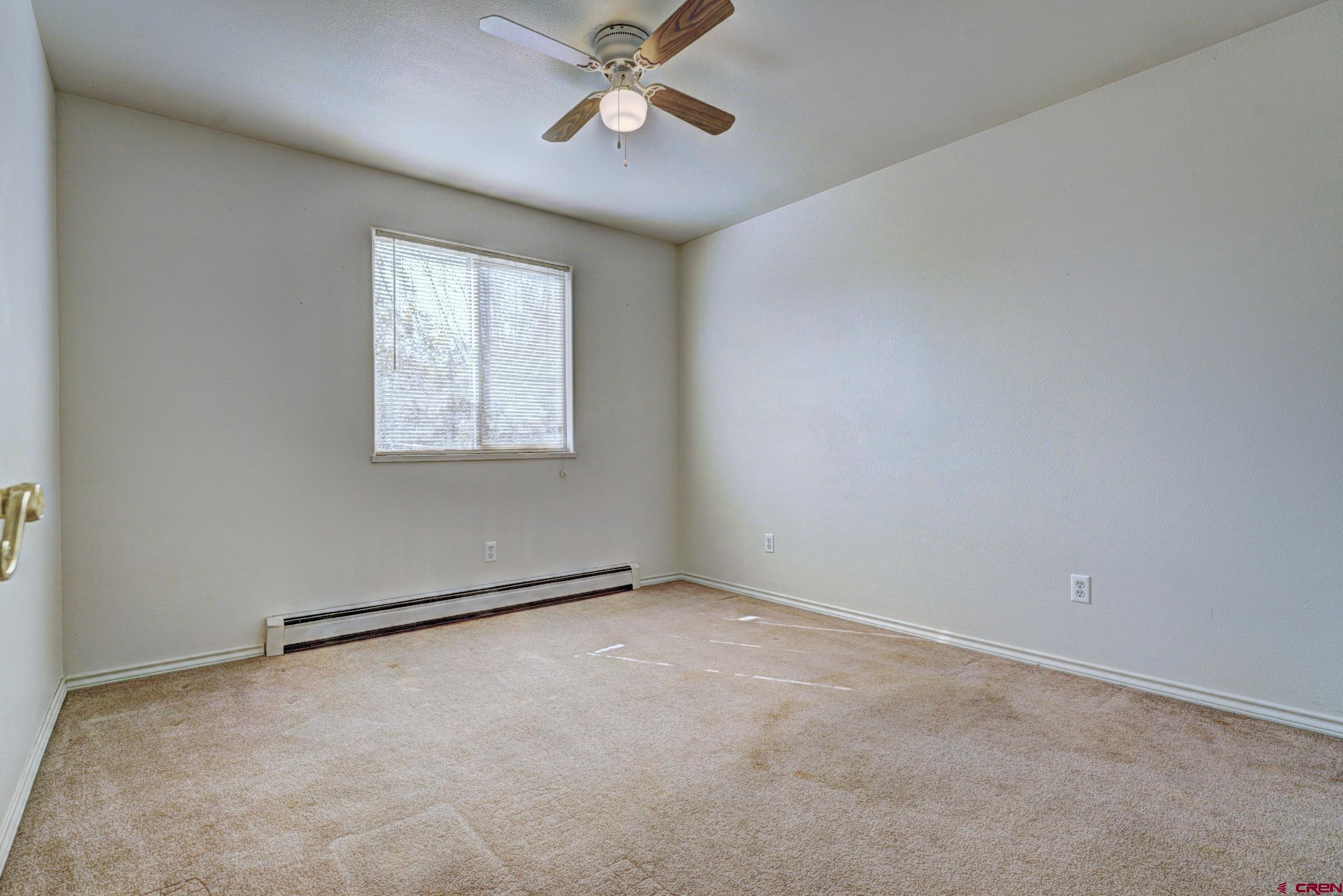 3119 D 3/4 Road Grand Junction, CO 81504 - Photo 20 of 31 an empty room with windows and fan