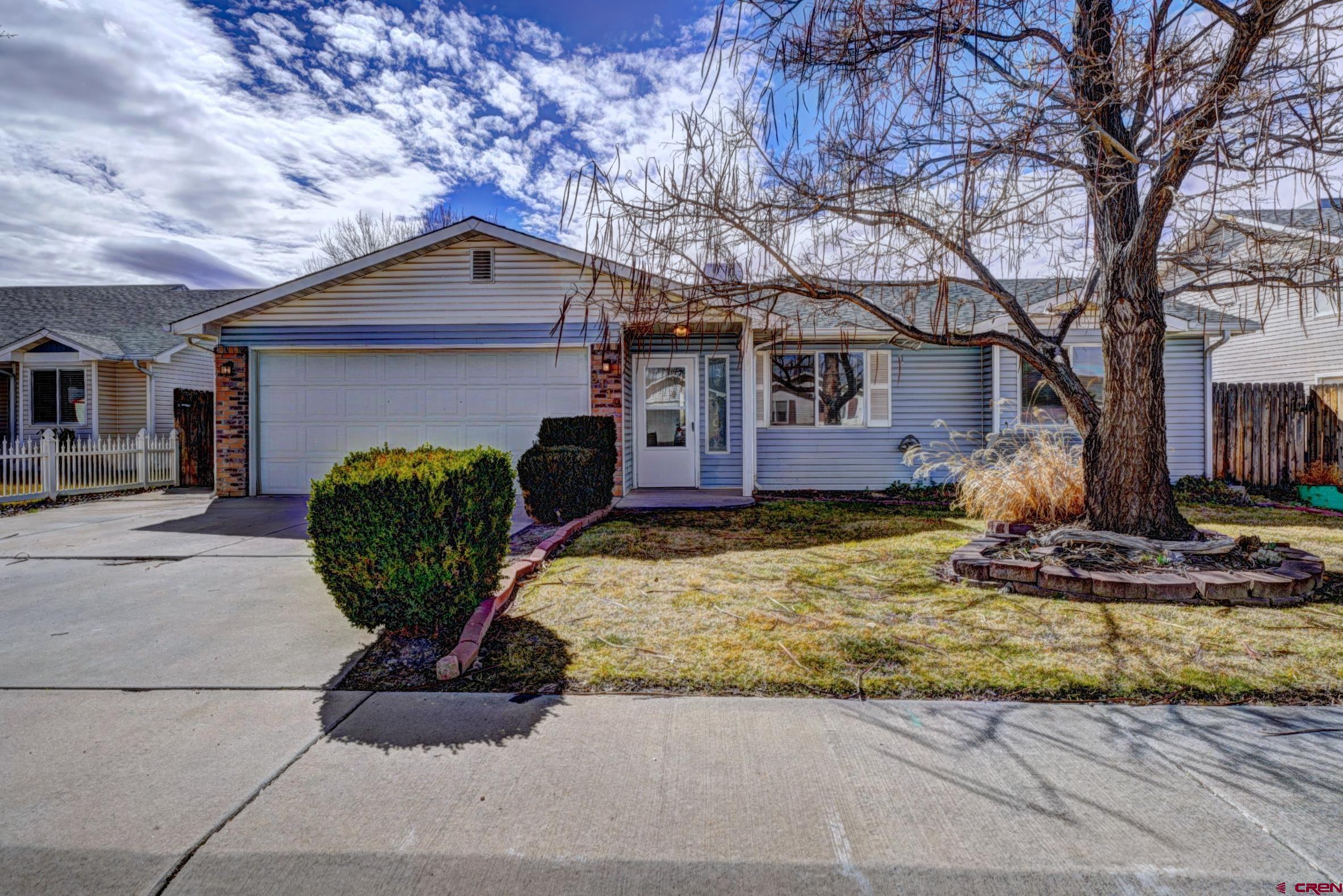 3119 D 3/4 Road Grand Junction, CO 81504 - Photo 2 of 31 a view of a house with large tree and wooden fence