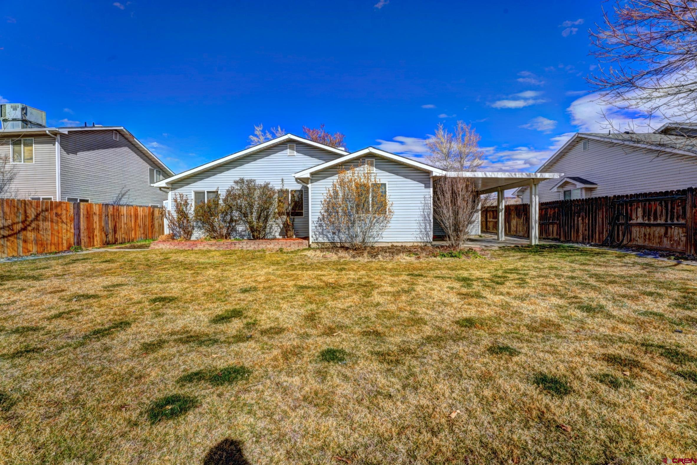 3119 D 3/4 Road Grand Junction, CO 81504 - Photo 29 of 31 a front view of a house with a yard