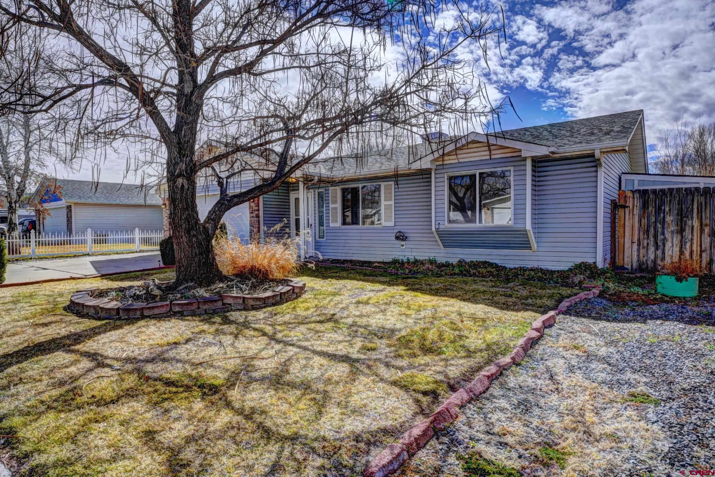 3119 D 3/4 Road Grand Junction, CO 81504 - Photo 31 of 31 a view of the house with yard and large tree