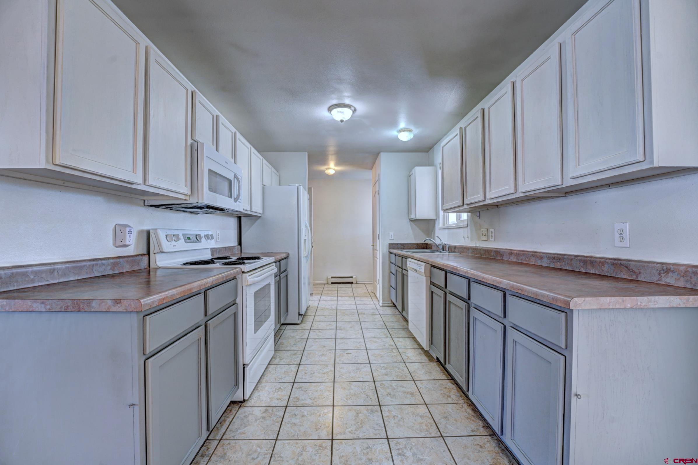 3119 D 3/4 Road Grand Junction, CO 81504 - Photo 7 of 31 a kitchen with stainless steel appliances granite countertop a sink stove and cabinets