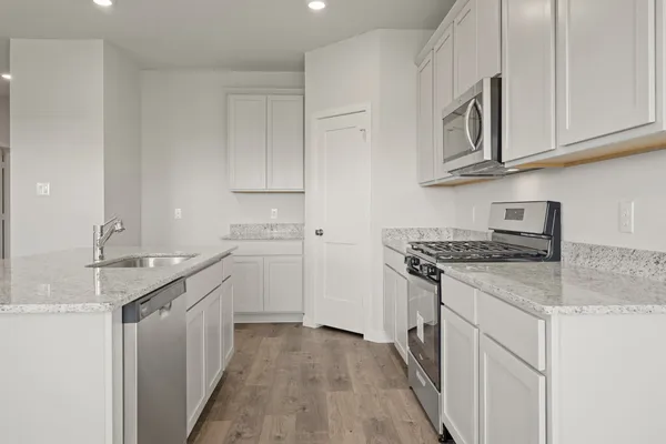 a kitchen with stainless steel appliances granite countertop a stove and a sink