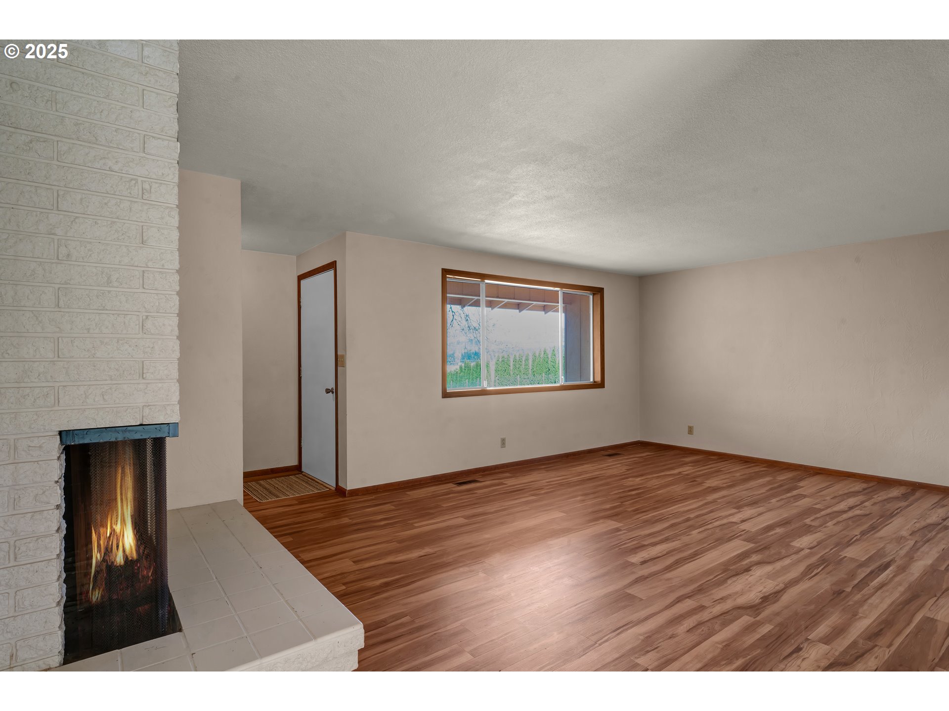 34520 Mathews Road Eugene, OR 97405 - Photo 2 of 42 a view of an empty room with wooden floor and a window