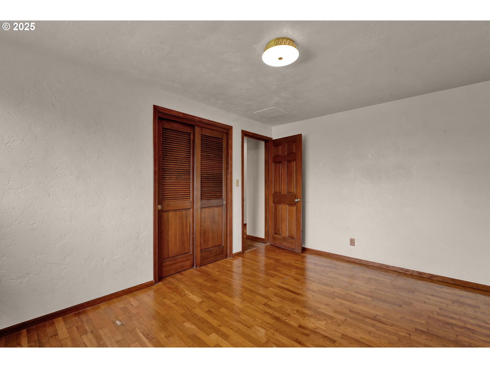 34520 Mathews Road Eugene, OR 97405 - Photo 25 of 42 a view of an empty room with wooden floor