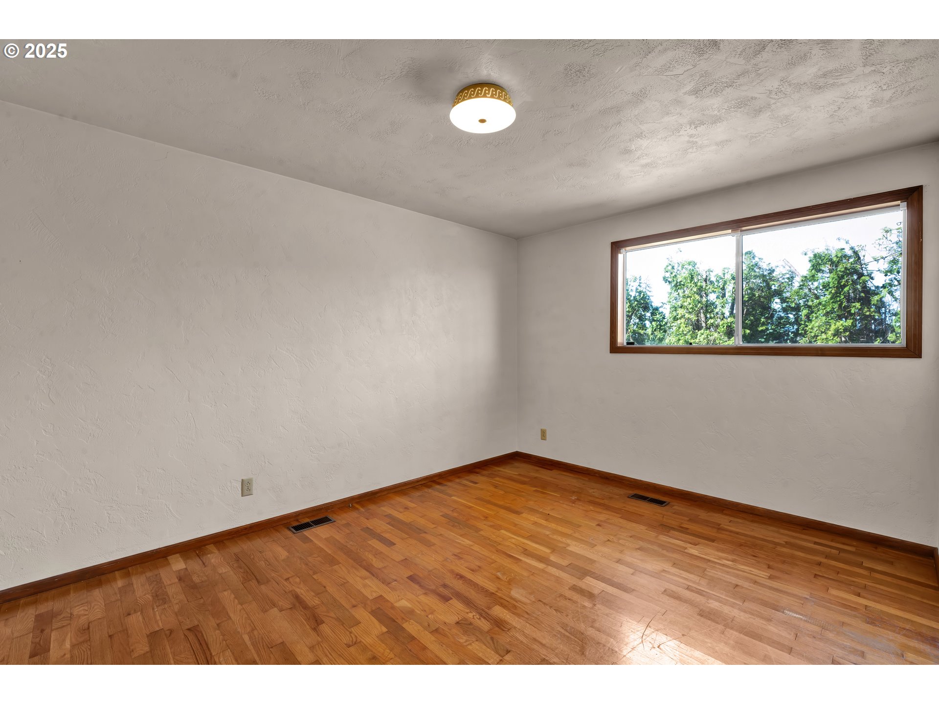 34520 Mathews Road Eugene, OR 97405 - Photo 26 of 42 a view of an empty room with wooden floor and a window