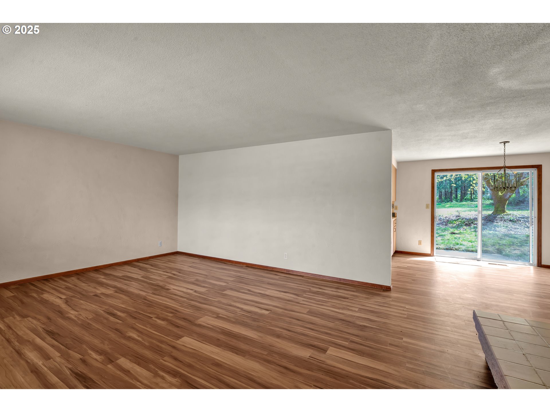 34520 Mathews Road Eugene, OR 97405 - Photo 8 of 42 a view of an empty room with wooden floor and a window