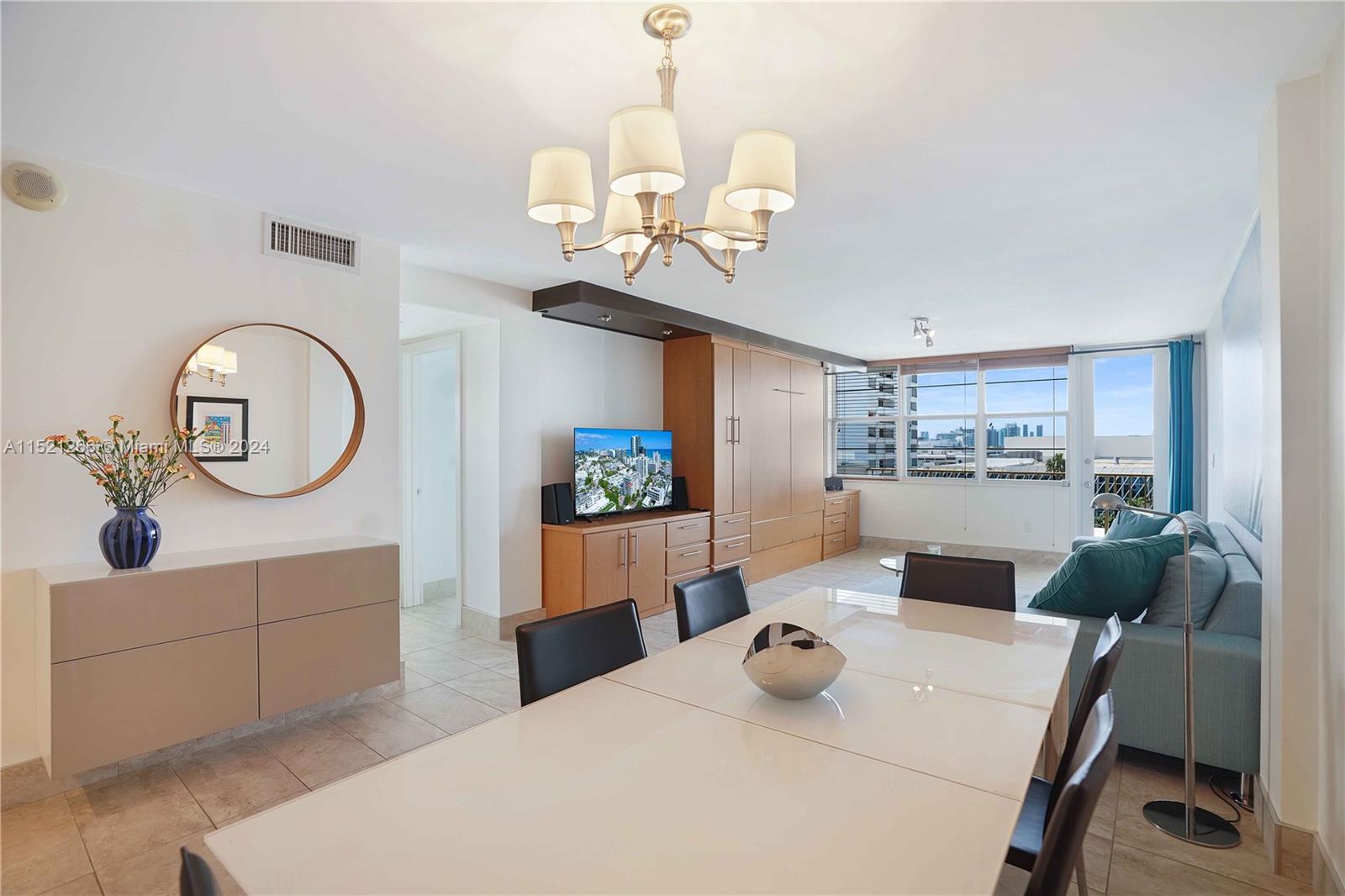 245 18th Street, Unit 902 Miami Beach, FL 33139 - Photo 15 of 54 a view of a dining room with furniture and a chandelier