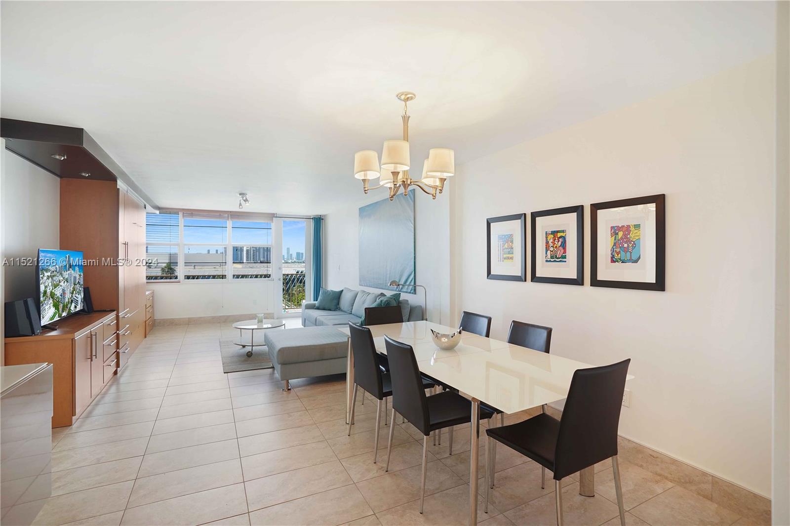 245 18th Street, Unit 902 Miami Beach, FL 33139 - Photo 19 of 54 a dining room with wooden floor a chandelier a glass table and chairs