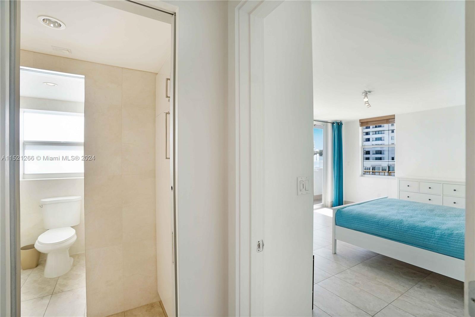 245 18th Street, Unit 902 Miami Beach, FL 33139 - Photo 35 of 54 a bedroom with a bed and a view of bathroom