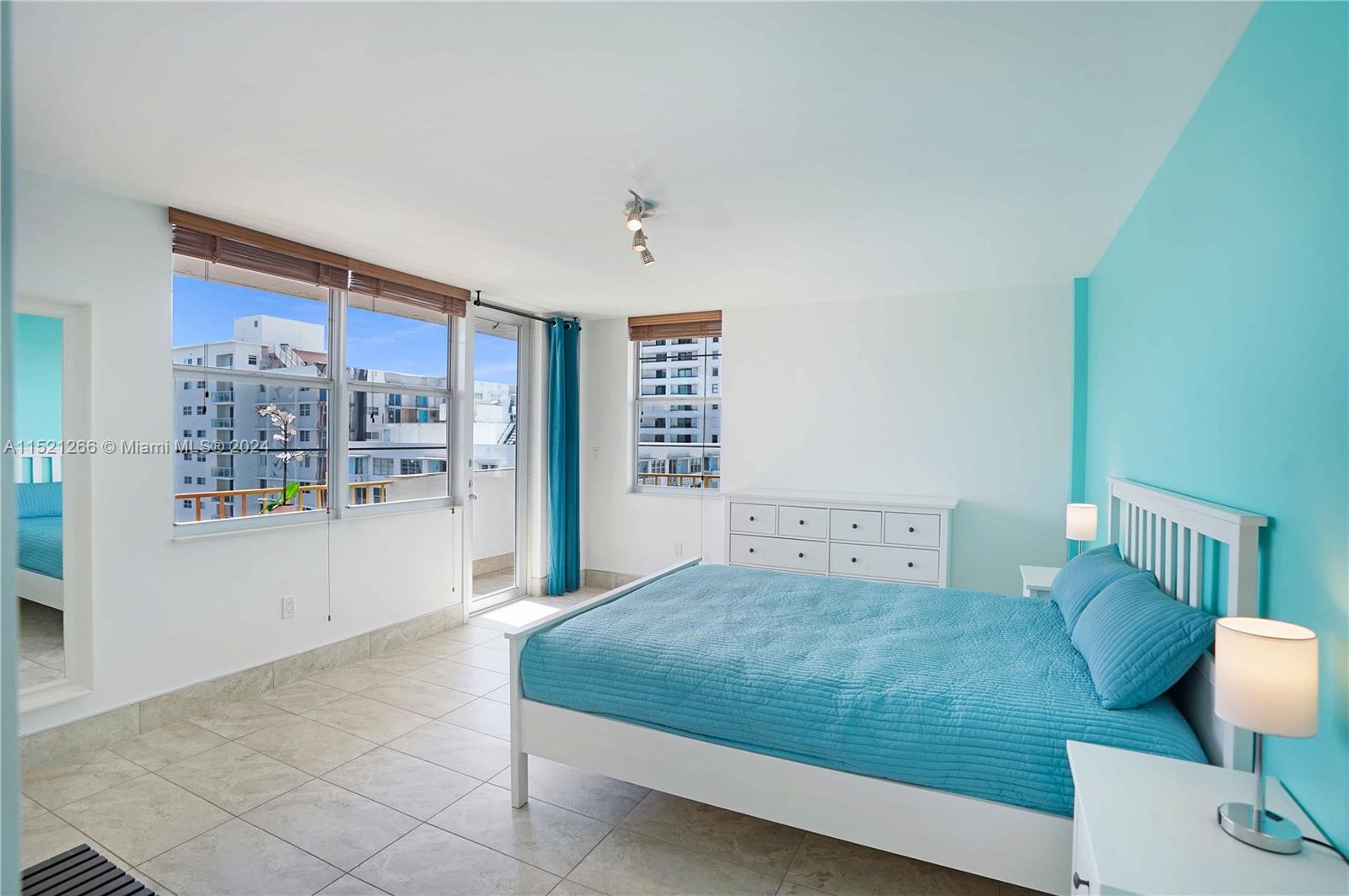 245 18th Street, Unit 902 Miami Beach, FL 33139 - Photo 36 of 54 a bedroom with a large bed and a potted plant