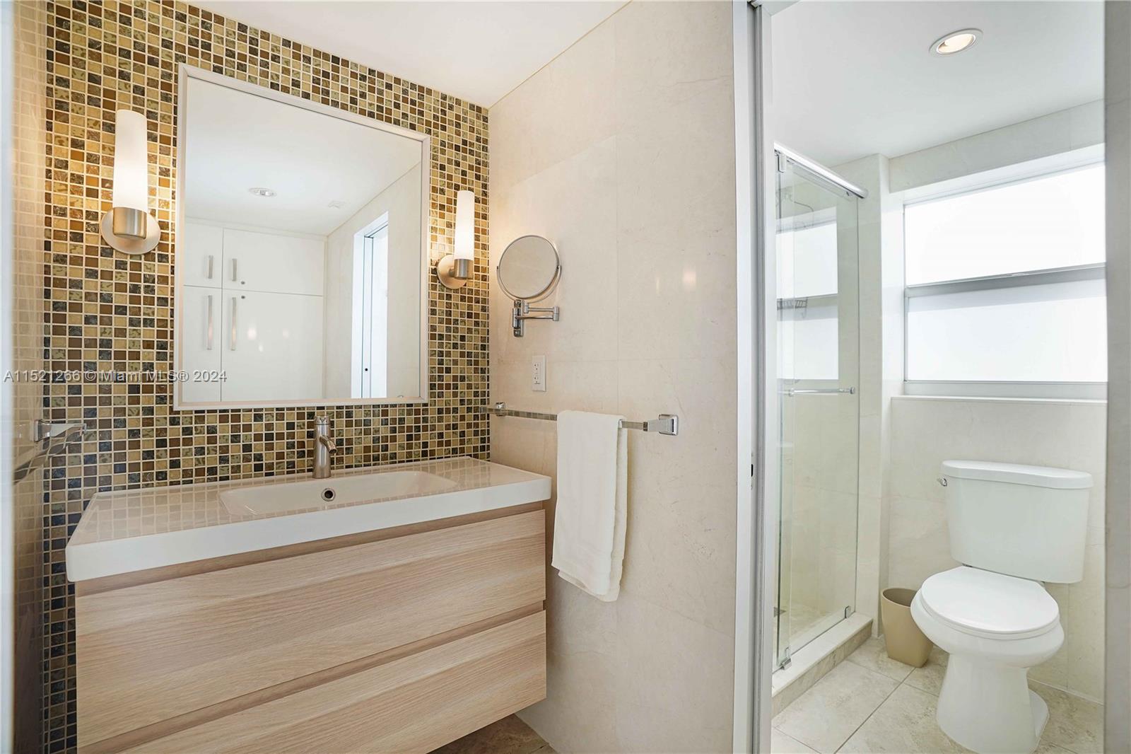 245 18th Street, Unit 902 Miami Beach, FL 33139 - Photo 46 of 54 a bathroom with a sink toilet and shower
